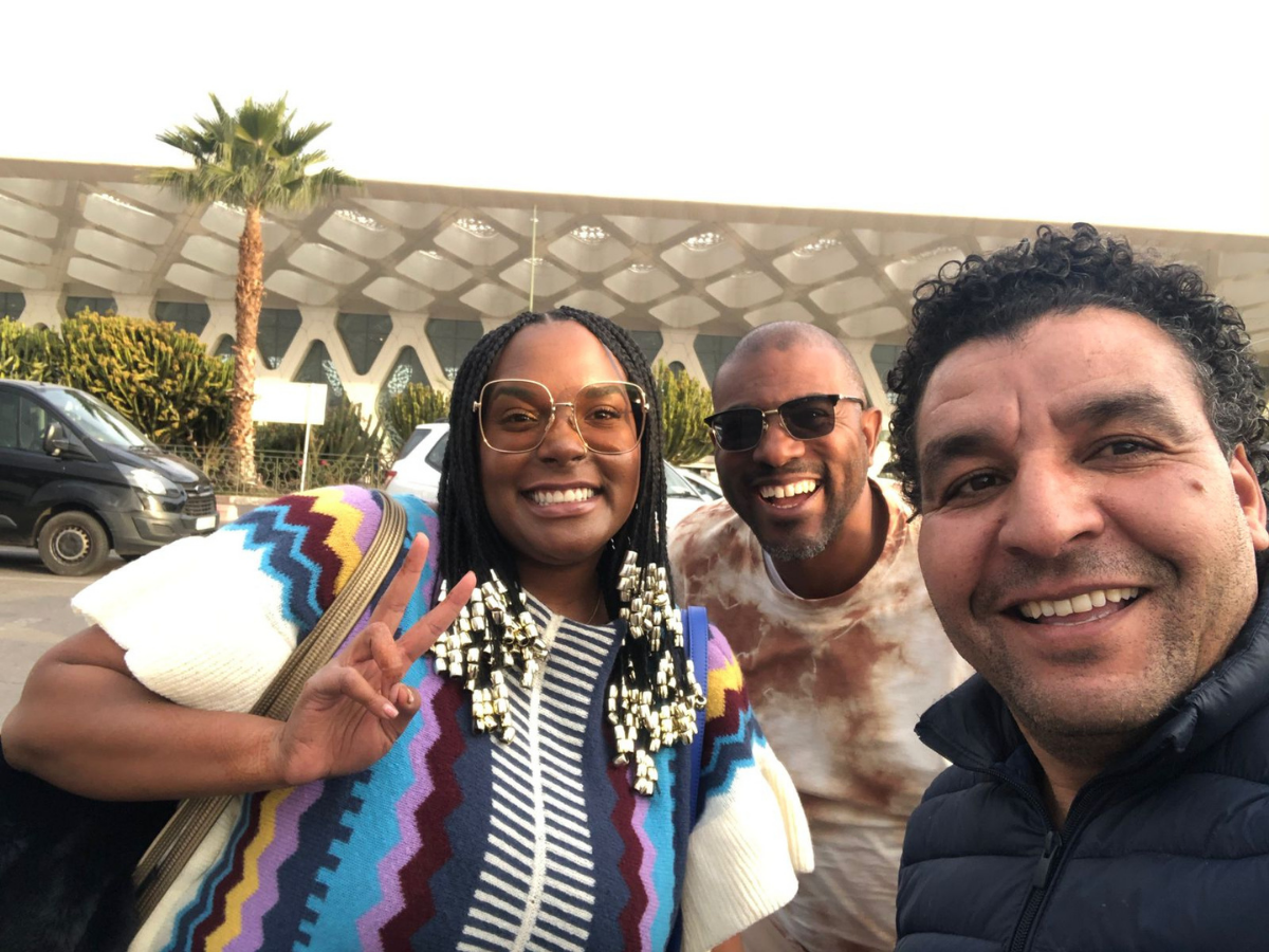 Omar with travelers in modern setting